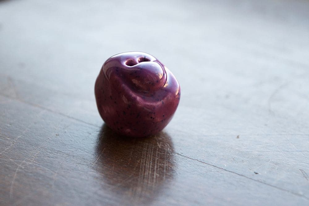 Plum on wooden surface