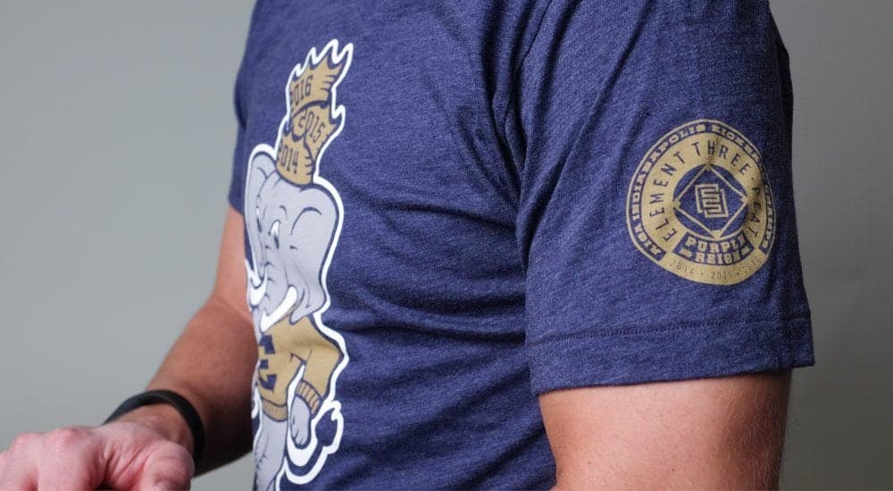 Closeup of navy Element Three branded t-shirt showing logo and seal details