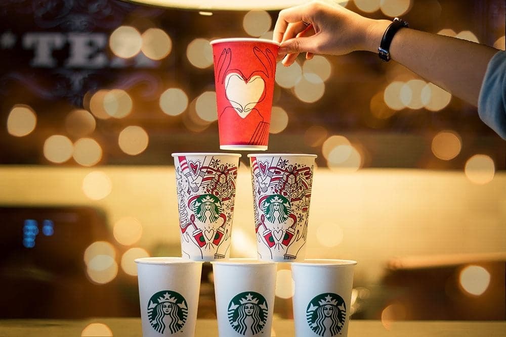 Starbucks coffee cups and holiday beverage cups displayed