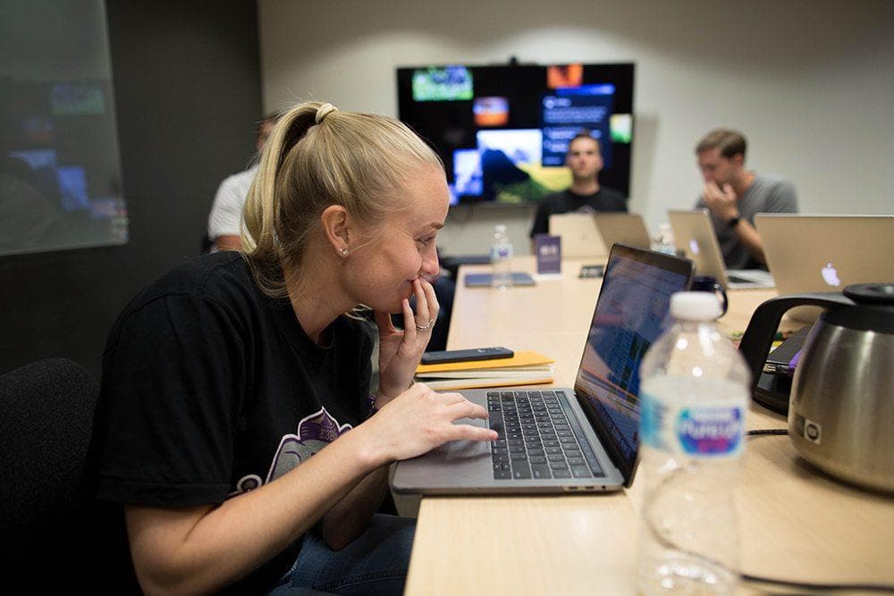 Woman in black shirt working at laptop in modern office