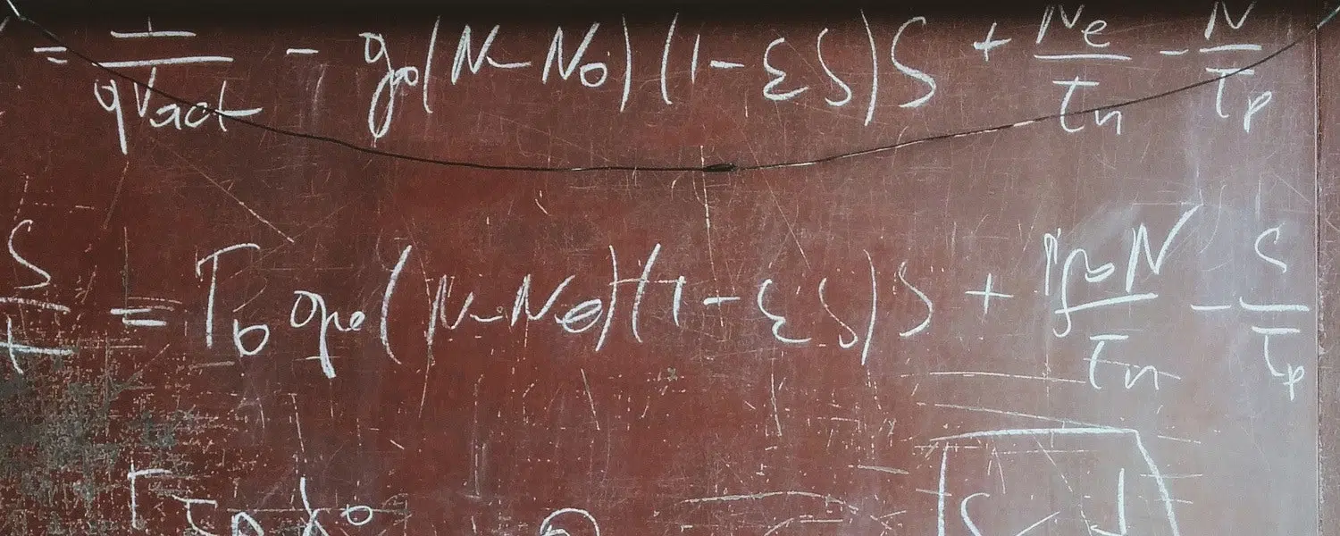 formula scribbled on a brick wall