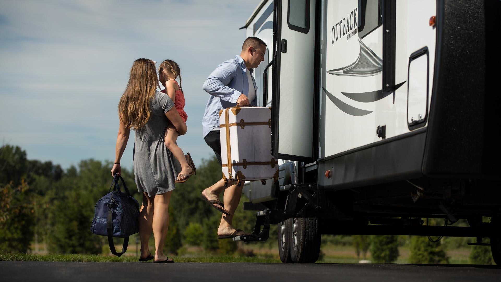 family climbing into their RV