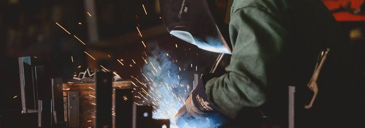 man welding in a factory