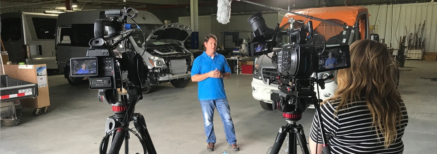 video crew filming in an RV workshop