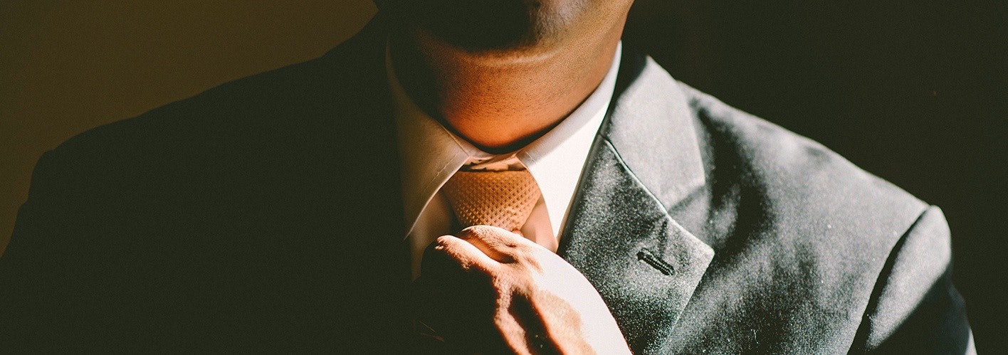 Man adjusting his neck-tie