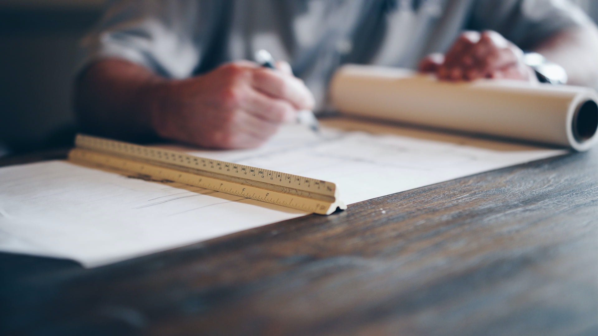 Arm on Table with Ruler and Paper