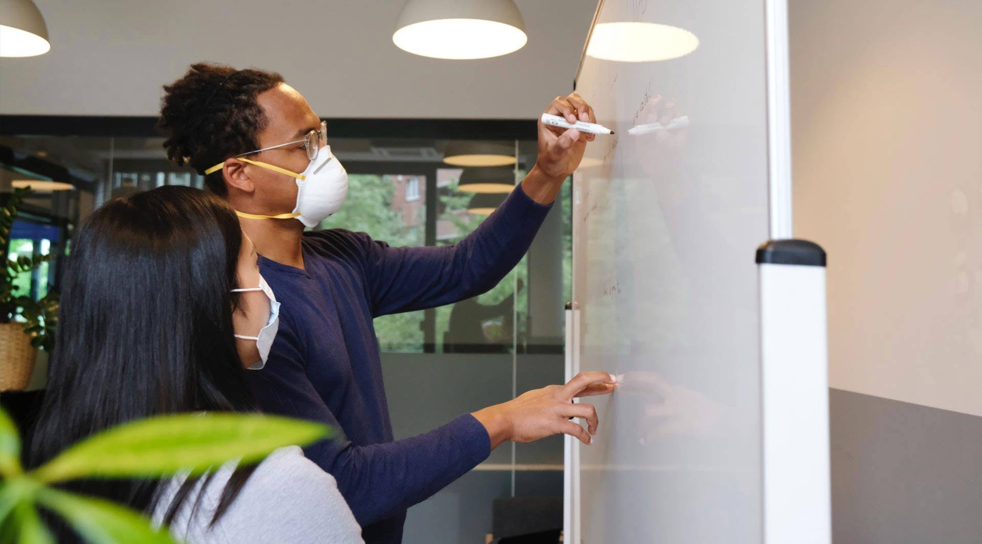 Man and Woman Whiteboarding a Strategy