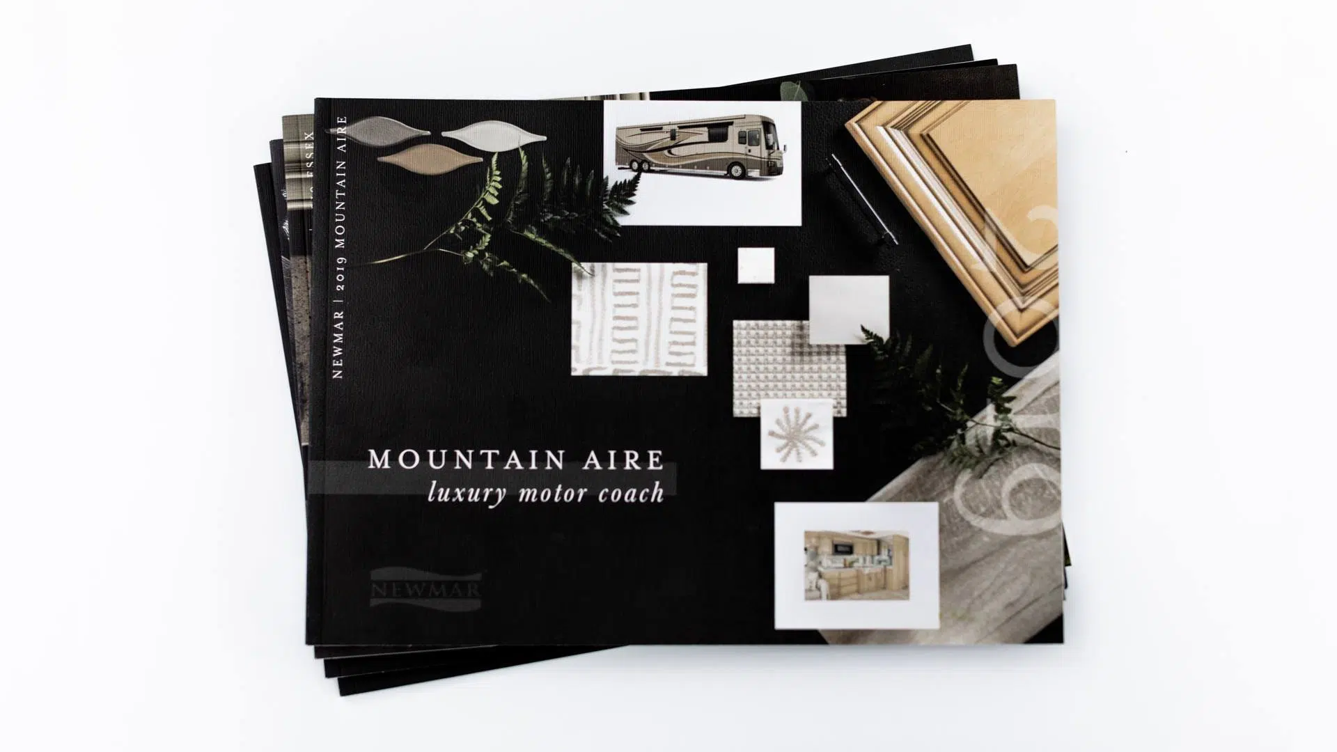 stack of product brochures for mountain aire newmar rv